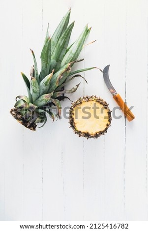 Pineapple on white wood board with copy space
