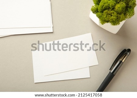 Photo of business cards stack with pen. Template for branding identity. Top view