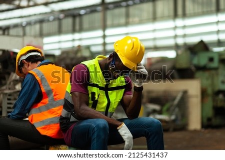 A group of workers or technicians in an industrial plant. Feeling stressed and tired from work. Royalty-Free Stock Photo #2125431437