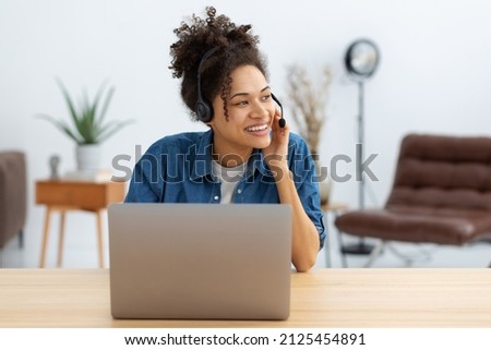 Portrait of happy African American female employee customer support services in headset, online consultation. Woman call center. Female customer support or sales agen Royalty-Free Stock Photo #2125454891