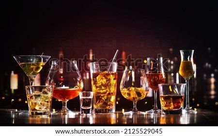 Assortment of hard strong alcoholic drinks and spirits in glasses on bar counter Royalty-Free Stock Photo #2125529045