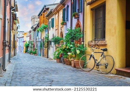 Narrow street of the village of fishermen San Guiliano with colorful houses and a bicycle in early morning in Rimini, Italy Royalty-Free Stock Photo #2125530221