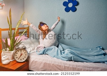 Baby girl woke up in a good mood, stretching. I slept well, it's time to get up and good morning. Healthy sleep. Royalty-Free Stock Photo #2125552199
