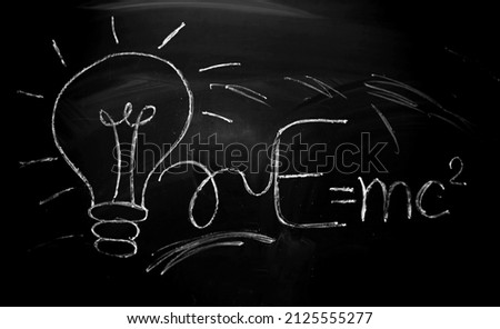 Board with chalk. The equation for the energy of light is written on the blackboard with chalk. Geometry and trigonometry. School