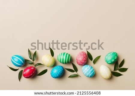Colorful Easter eggs with spring flower leaf isolated over white background. Colored Egg Holiday border. Royalty-Free Stock Photo #2125556408