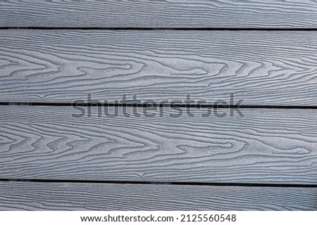 Wood grain effect composite decking boards surface.