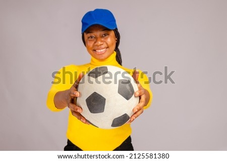 lady isolated over white background pointing out the ball she is holding