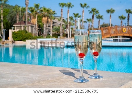 champagne glasses by the pool