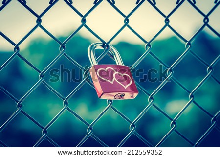 Lockers symbolizing love forever on the fence with vintage style Royalty-Free Stock Photo #212559352