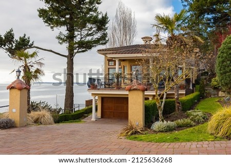 Luxury house in Vancouver, Canada. Big luxury house with a patio on overcast cloudy day. Selective focus, nobody.