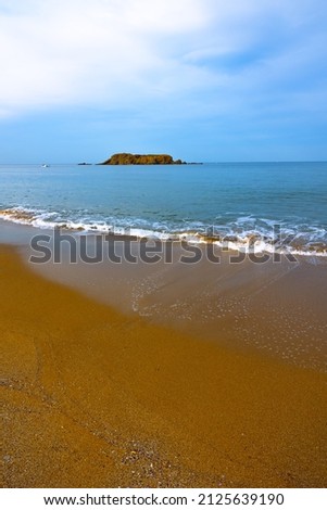 Beach background. Calm sea and island with cloudy sky. Moody sea and beach background photo.
