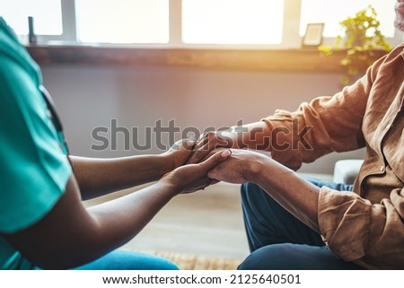 Photo of Caring nurse or doctor holding an elderly hand with care. Nurse physiotherapist doctor holding hands of a senior or elderly old man patient with love, care, helping, encourage and empathy  Royalty-Free Stock Photo #2125640501