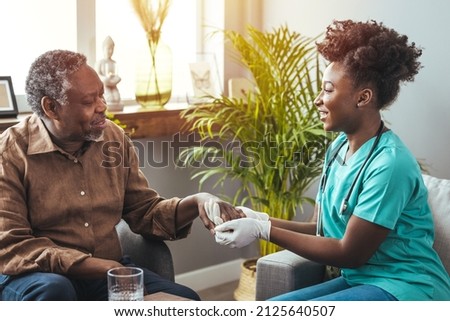 Closeup of a support hands. Closeup shot of a young woman holding a senior man's hands in comfort. Female carer holding hands of senior man  Royalty-Free Stock Photo #2125640507