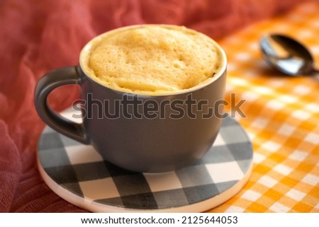 cake in a mug. dessert. Vanilla dessert cooked in the microwave. cake mug. Easy, fast to cook.vanilla biscuit in a spoon . Close-up of banana flavored mugcake. homemade cupcake recipe. Royalty-Free Stock Photo #2125644053
