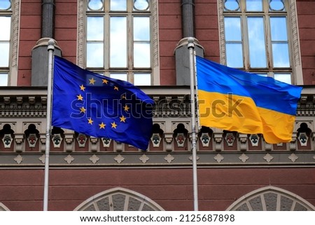 Flags of Ukraine and European Union in Kiev. Yellow-blue state Ukrainian and European Union flags in Kyiv, near  National Bank, Independence Constitution Day, National holiday. Royalty-Free Stock Photo #2125687898