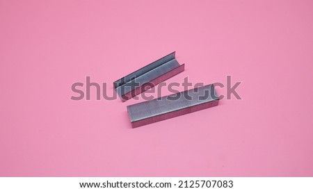 Assorted office supplies, Stapler on pink background