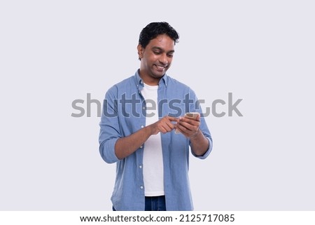 Indian Man Standing Using Phone Isolated. Man Texting on Phone. Technology Royalty-Free Stock Photo #2125717085