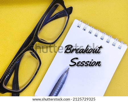 Glasses, pens, and a notebook with the words Breaking Session on a yellow background.