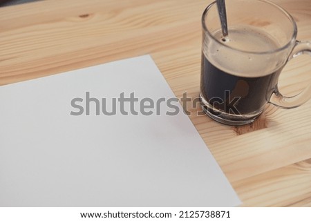 white paper on wood table with coffee