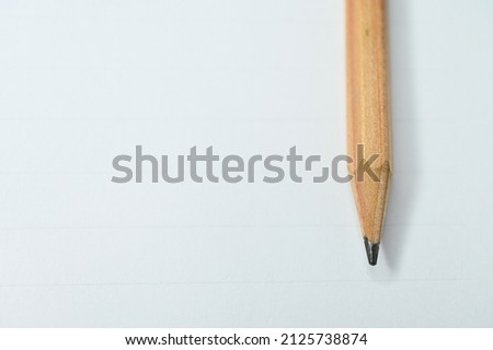 wooden pencil on white paper