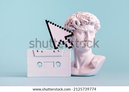 Antique statue is bust of David and pixel mouse pointer and audio cassette. Concept of vaporwave and nft and cyberpunk.