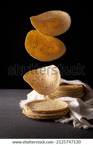 Corn Tortillas. Food made with nixtamalized corn, a staple food in several American countries, an essential element in many Latin American dishes. Royalty-Free Stock Photo #2125747130