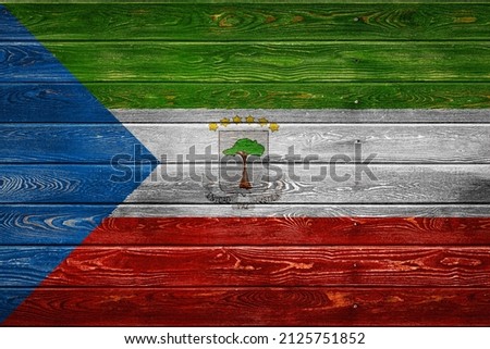The national flag of Equatorial Guinea is painted on a camp of even boards nailed with a nail. The symbol of the country.