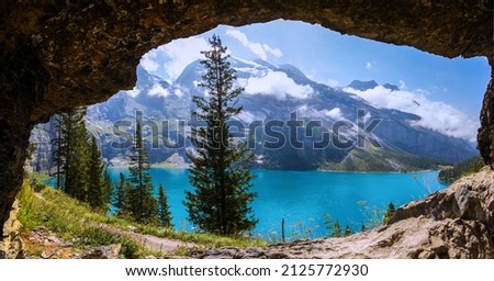 Beautiful panorama view from a curvy rock over the hiking path to the Oeschinensee Lake, Kandersteg, Switzerland Royalty-Free Stock Photo #2125772930