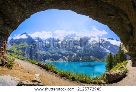 Beautiful panorama view from a curvy rock over the hiking path to the Oeschinensee Lake, Kandersteg, Switzerland Royalty-Free Stock Photo #2125772945