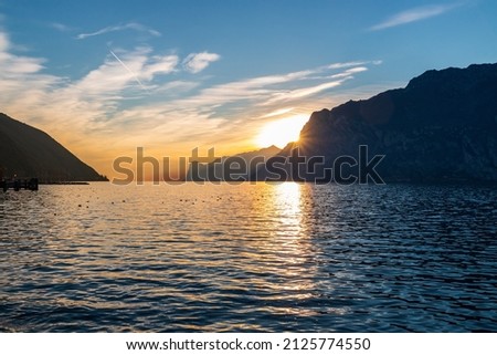 A magnificent sunset on the shore of Lake Garda in Torbole