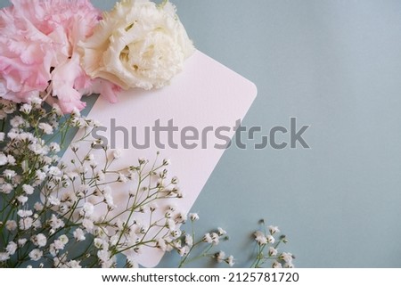  feminine wedding desktop with baby's breath Gypsophila flowers and pink flowers on pale green background. Empty space. Floral frame, web banner. Top view. Picture for blog or social media