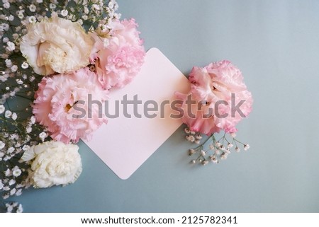 feminine wedding desktop with baby's breath Gypsophila flowers and pink flowers on pale green background. Empty space. Floral frame, web banner. Top view. Picture for blog or social media