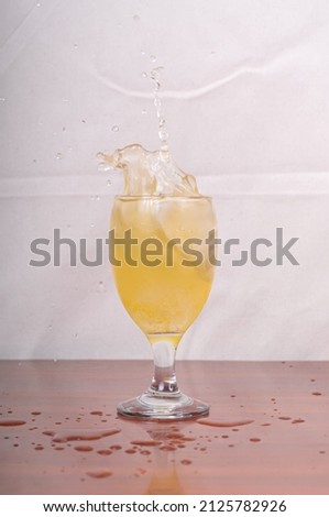 potrait shoot of a splash of lemon water in a glass. 