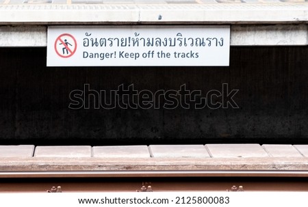 Warning signs near tracks for the Bangkok BTS skytrain