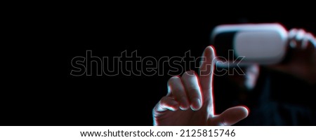 Vr glasses virtual reality. Blured young man in digital headset for virtual reality technology on dark background with glitch effect. Amazing technology, online game, entertainment