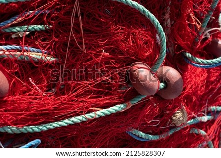 fishing net with red twine Royalty-Free Stock Photo #2125828307