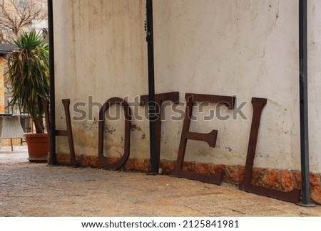 Retro metal hotel lettering on the ground, leaning against the wall
in old town of Skopje, North Macedonia