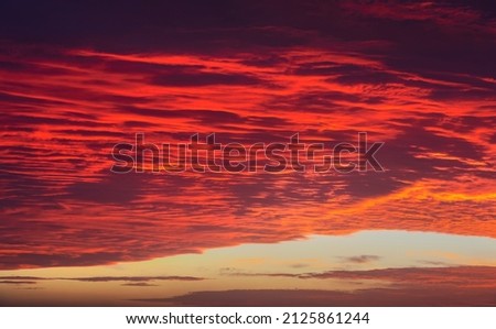 Sky at sunset texture background overlay. Dramatic red, orange, purple clouds. High resolution photography perfect for sky replacement