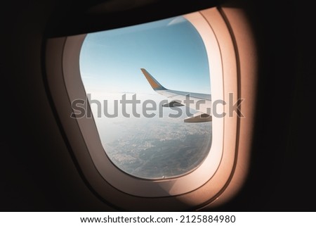 View from the window of the plane on the wing over the beautiful city of Thessaloniki in a haze of clouds Royalty-Free Stock Photo #2125884980