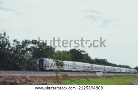 The economy class train passes by in gedebage Bandung, blurred image. Royalty-Free Stock Photo #2125894808