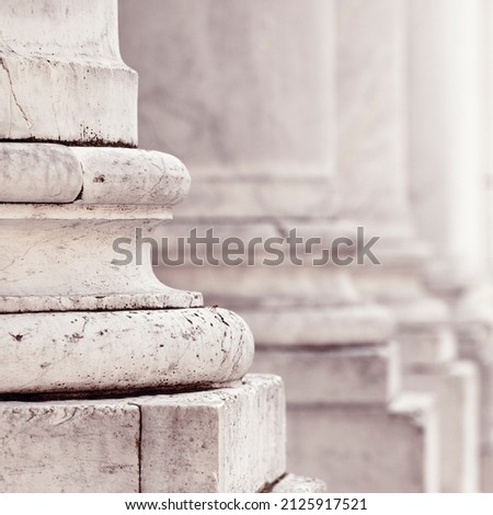 Base of the marble columns of a medieval Italian church. Royalty-Free Stock Photo #2125917521