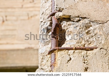 Old reinforced concrete structure with damaged and rusty metallic reinforcement bars. Royalty-Free Stock Photo #2125917566