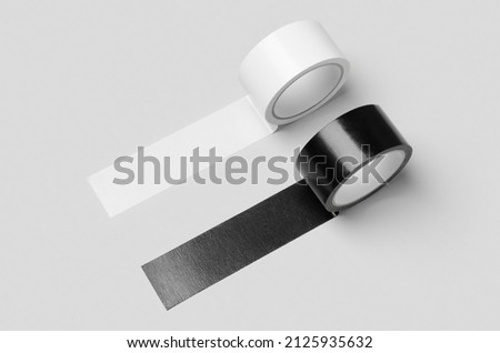 White and black unrolled duct tapes mockup on a grey background. Royalty-Free Stock Photo #2125935632