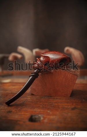 vintage smoking pipe on the leather background, close up