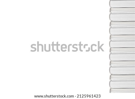 Banner with hardback books tower isolated on white background. Vertical books border with copyspace. Education and reading leisure concept. High quality photo