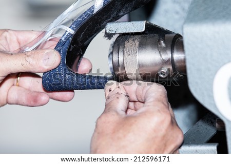 the shoemaker repairs a woman shoe Royalty-Free Stock Photo #212596171