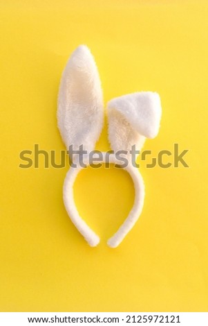 Happy Easter holiday concept, bunny ear on yellow background. top view