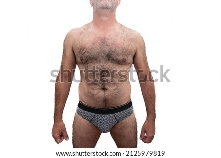 An athletic elderly Caucasian man, with bare hairy chest. Isolated on white background.