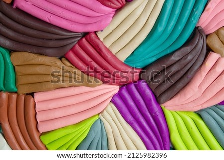 plasticine of different colors, different shapes, pink, brown, green, purple. multicolored background, texture. plasticine background