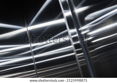Brushed shiny metal wall with blurred reflections pattern, abstract background photo